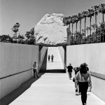 grayscale photo of people on bridge